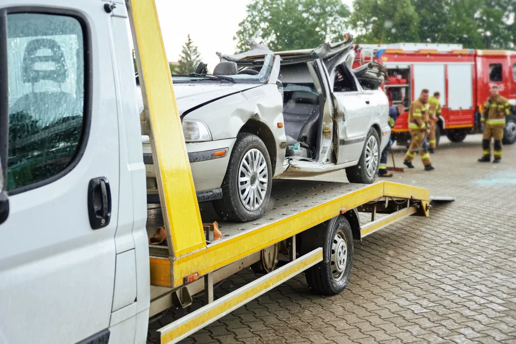 A crashed car loading into tow truck after a traffic.